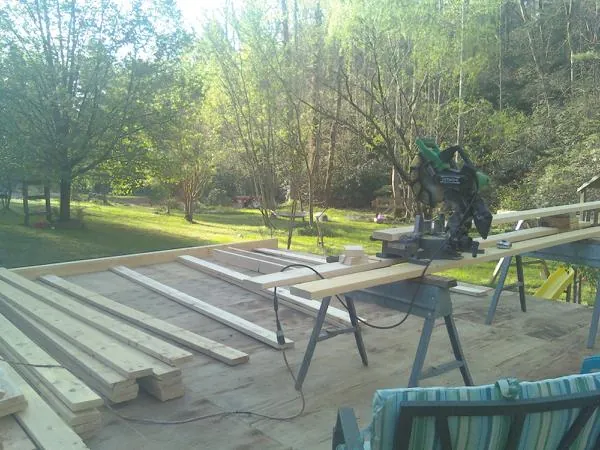 Miter saw and framing lumber on a deck under construction in Saint Clair Shores