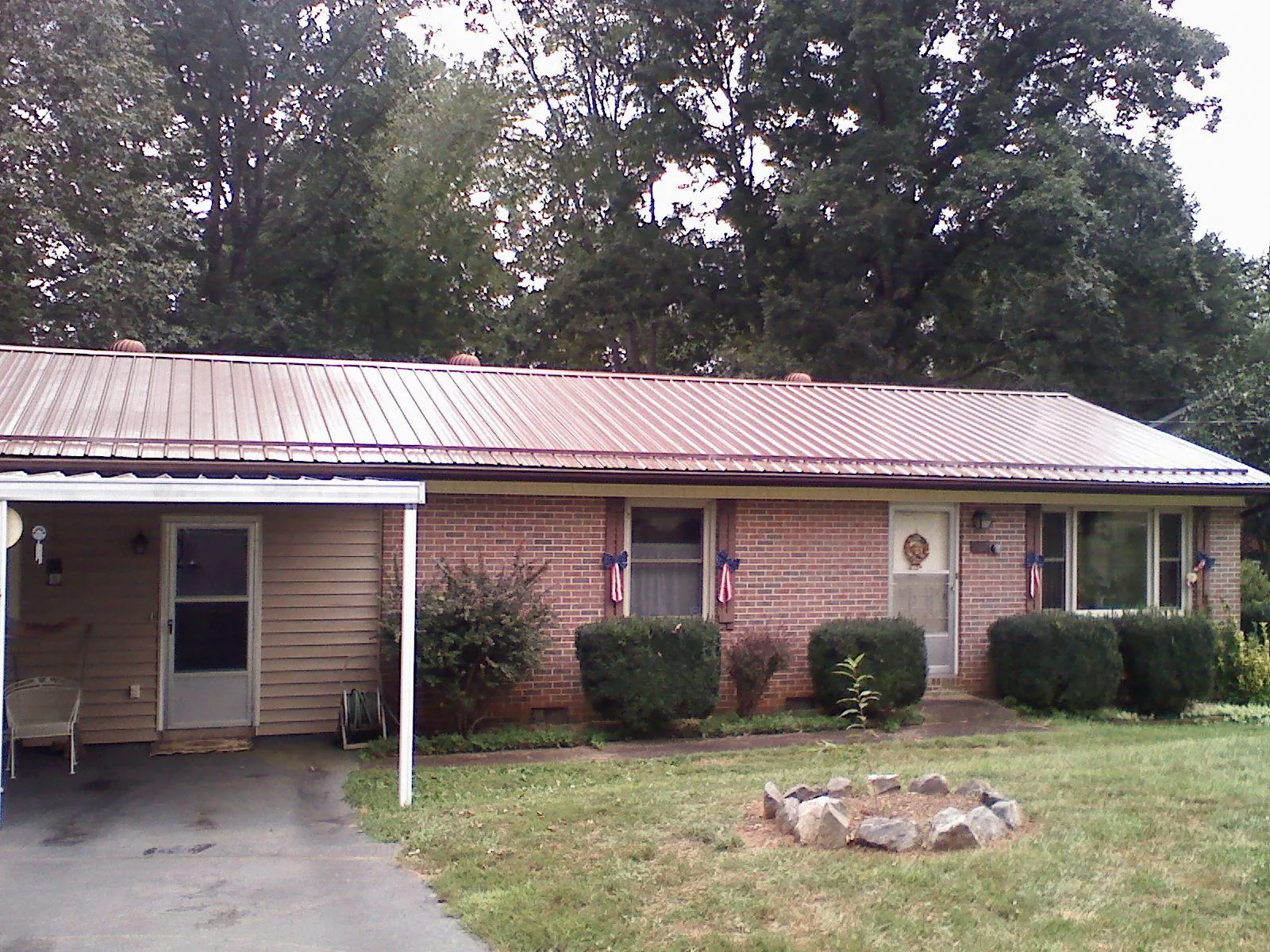 Bronze metal roof and carport on a brick ranch home — Roof Repair work by our crew in Saint Clair Shores
